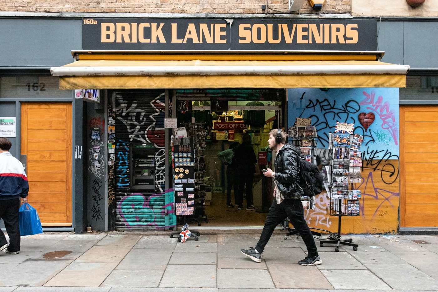 A person walking past a shop on a UK high street